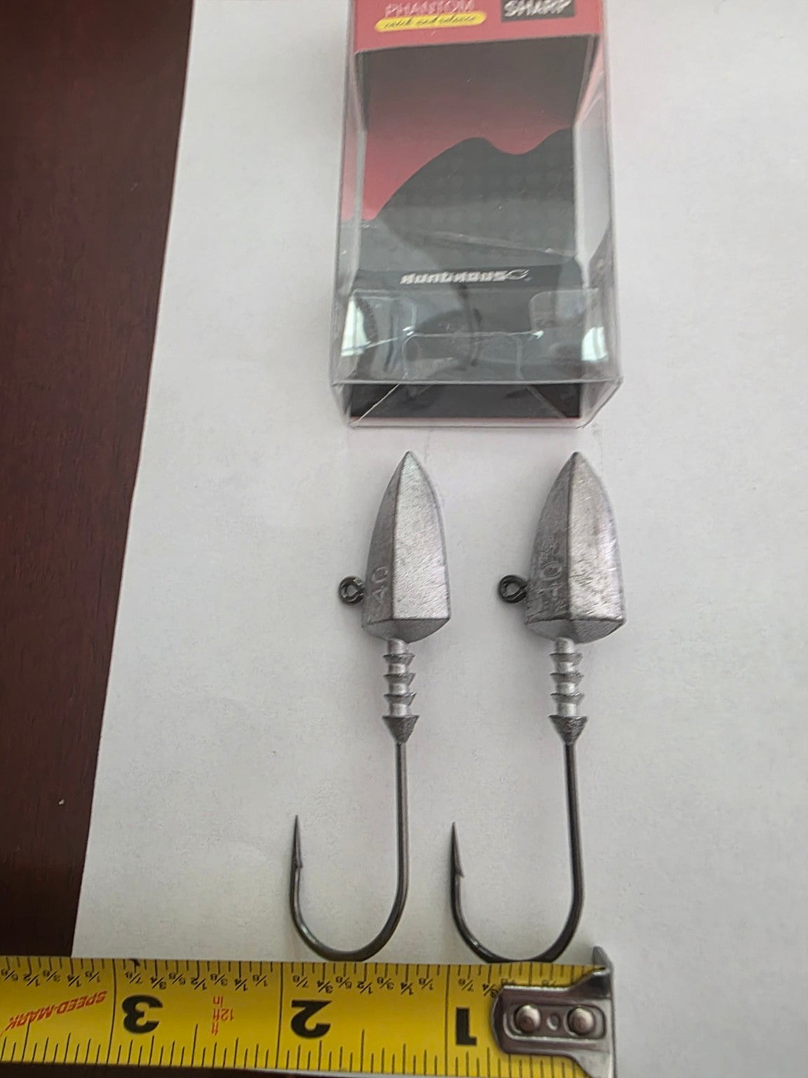 Two unpainted 40 gram jig heads with package and size reference